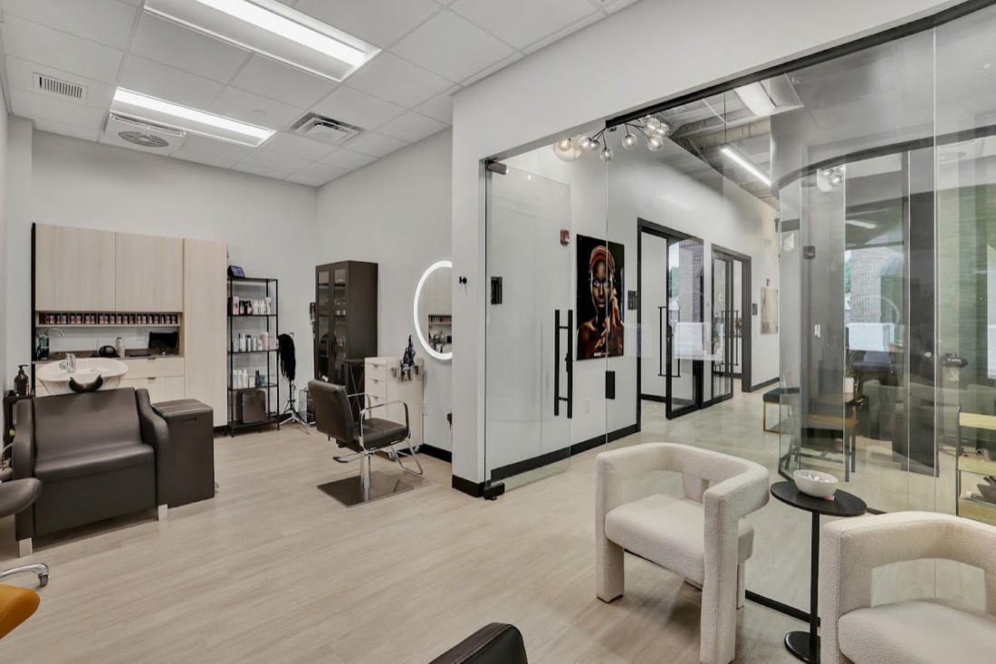 Salon with frameless glass partition suites by Interior Glass Solutions