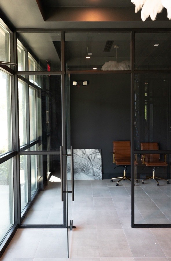 Black-framed glass entrance and lobby partitions — DJ and Lindsey