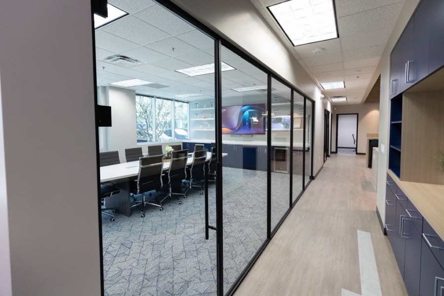 Black-framed glass conference room wall — Russell Roland