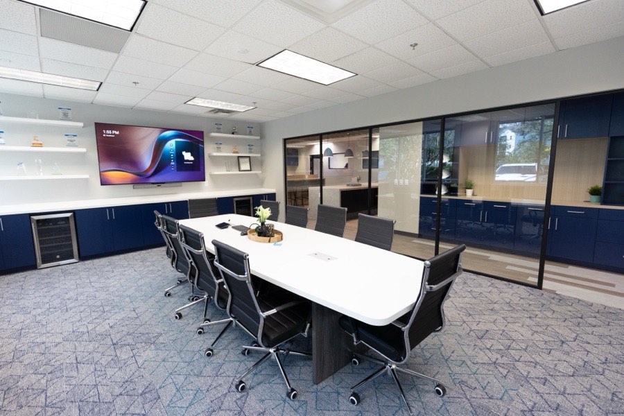 Black-framed glass conference room wall with navy interior — Russell Roland