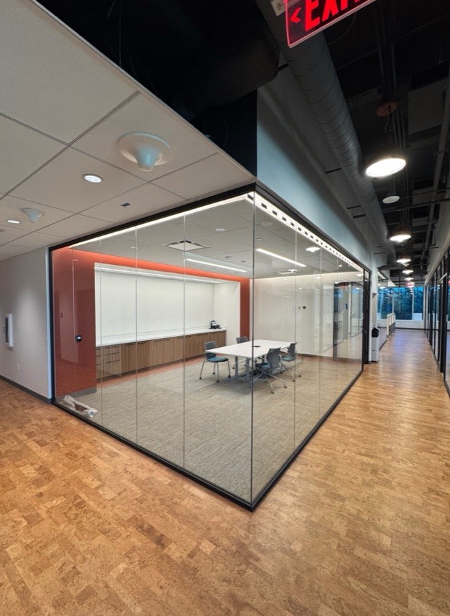 Glass-enclosed meeting room with warm wood accents — Mayo Clinic