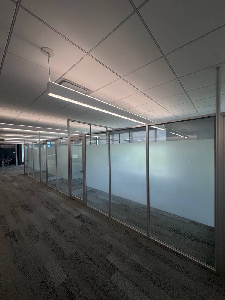 Silver-framed glass office fronts with frosted privacy bands — Duo’s Technologies