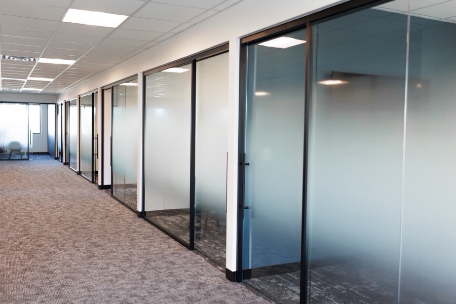 Black-framed frosted glass office partitions — ATP Tour