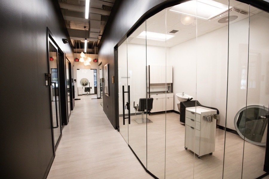 Salon suite corridor with black-framed glass fronts