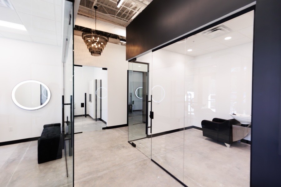Black-framed glass salon suite fronts with mirrors