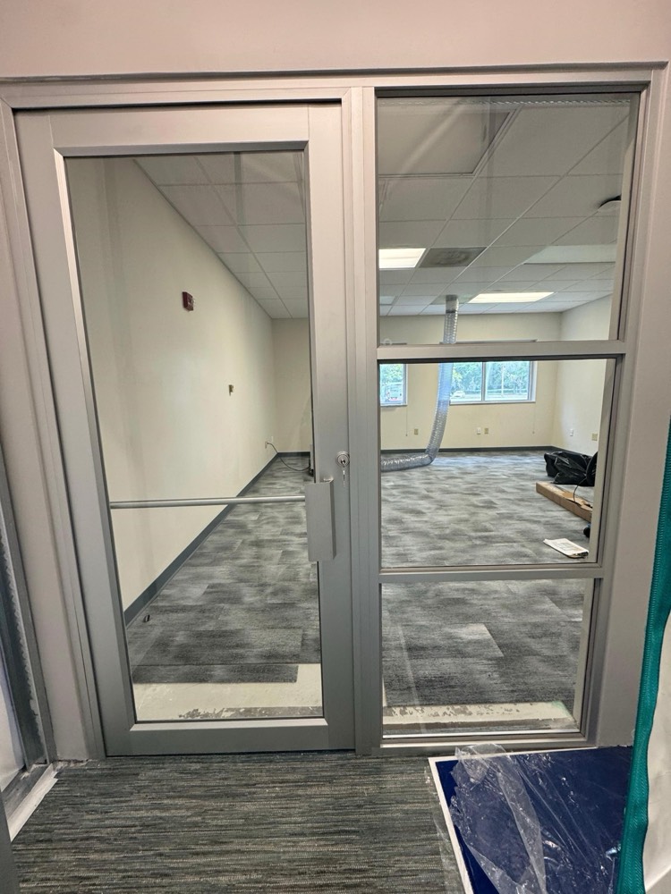 Silver aluminum-framed glass door and sidelight — JU STEAM, Jacksonville University