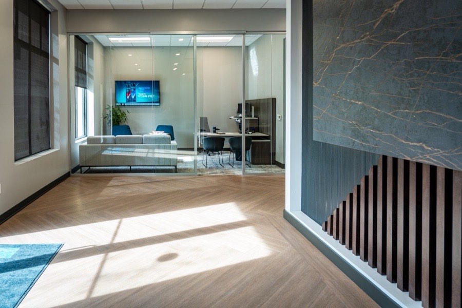 Office lobby glass front with marble accent wall — Renasant Bank