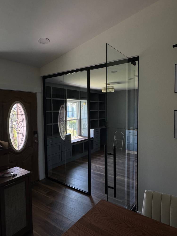 Black-framed glass wall and pivot door with ladder pull — Residential Office
