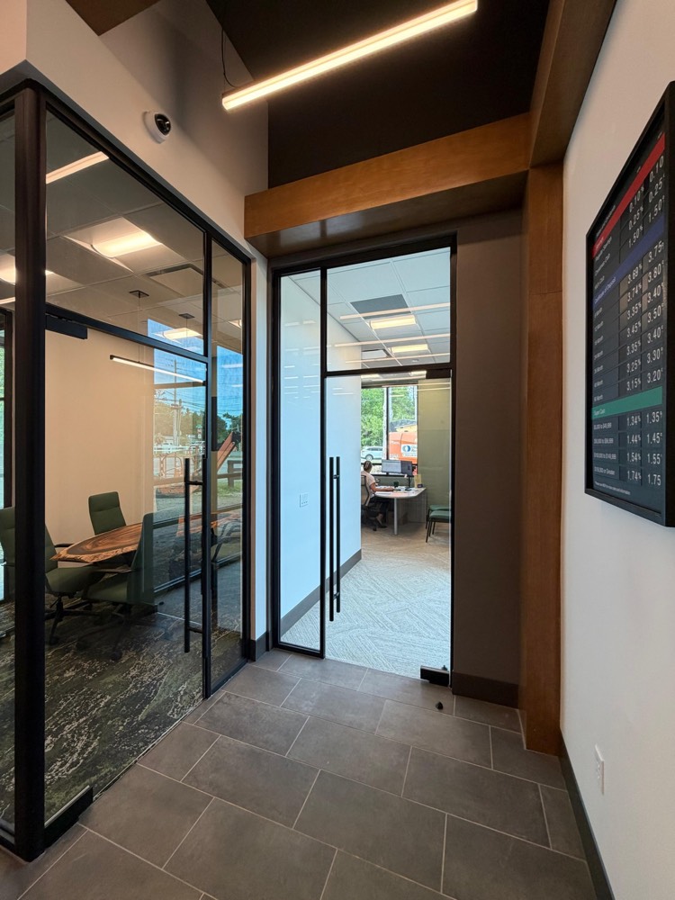 Black-framed glass office fronts and glass door with matte-black pulls — Tru Fi Credit Union, Callahan FL